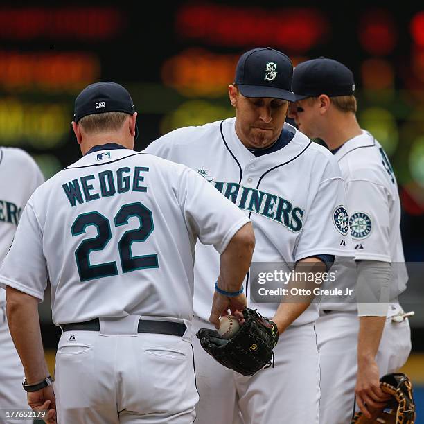 Starting pitcher Aaron Harang of the Seattle Mariners is removed from the game by manager Eric Wedge against the Los Angeles Angels of Anaheim at...