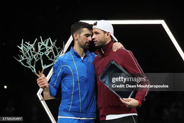 Winner Novak Djokovic of Serbia and runner-up Grigor Dimitrov of Bulgaria interact during the trophy ceremony after the Men's Singles final against...