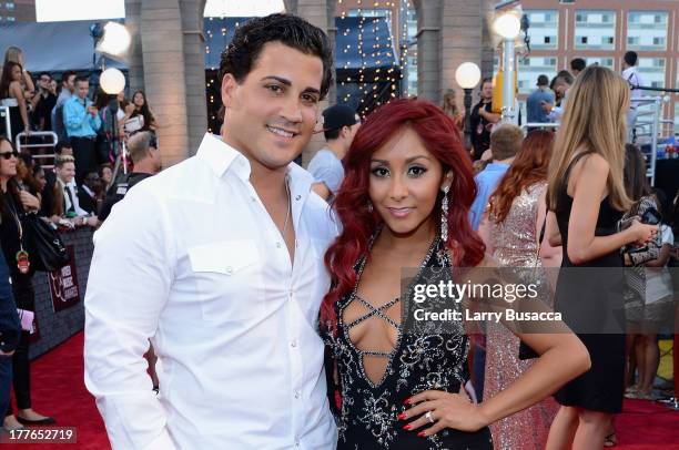 Television personality Nicole 'Snooki' Polizzi with husband Jionni LaValle attend the 2013 MTV Video Music Awards at the Barclays Center on August...