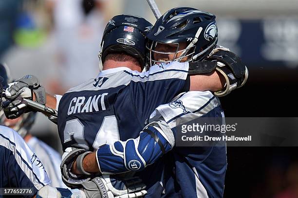 John Grant Jr. #24 of the Chesapeake Bayhawks is congratulated on a goal by teammate Drew Westervelt against the Charlotte Hounds during the MLL...