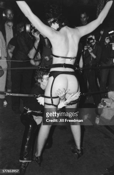Couple perform for the spectators at the 'Hellfire Club', a Sadomasochism club night in the pre-gentrified Meatpacking District, New York City, 1981.