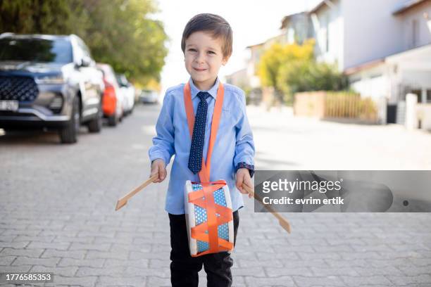 boy playing trumpet on the street - child beauty pageant stock pictures, royalty-free photos & images