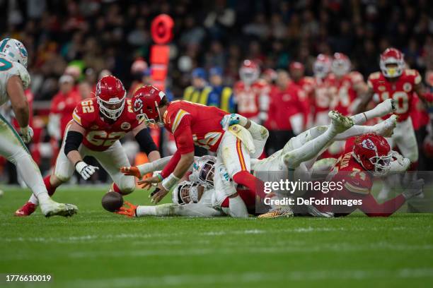 Patrick Mahomes of Kansas City Chiefs and Bradley Chubb of Miami Dolphins battle for the ball during the NFL match between Miami Dolphins and Kansas...