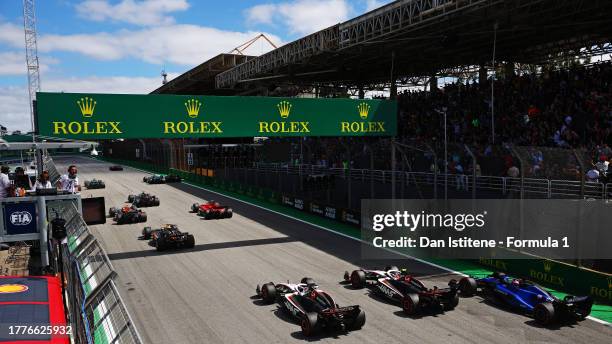 Kevin Magnussen of Denmark driving the Haas F1 VF-23 Ferrari, Nico Hulkenberg of Germany driving the Haas F1 VF-23 Ferrari and Alexander Albon of...