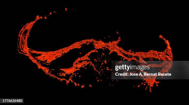 splashes and drops of red liquid on a black background. - metallic ink stock pictures, royalty-free photos & images