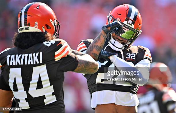 Grant Delpit of the Cleveland Browns talks with Sione Takitaki of the Cleveland Browns before the game against the Arizona Cardinals at Cleveland...