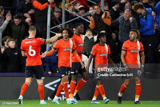 Tahith Chong of Luton Town celebrates with teammates after scoring the team's first goal during the Premier League match between Luton Town and...