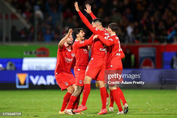 Tim Kleindienst of 1.FC Heidenheim celebrates with teammates after scoring the team's second goal during the Bundesliga match between 1. FC...