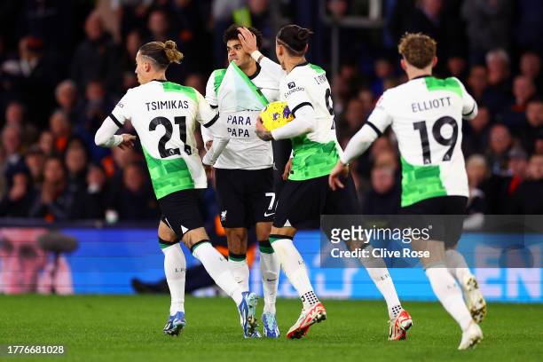 Luis Diaz of Liverpool celebrates with teammates after scoring the team's first goal to equalise by revealing a message underneath his match shirt...