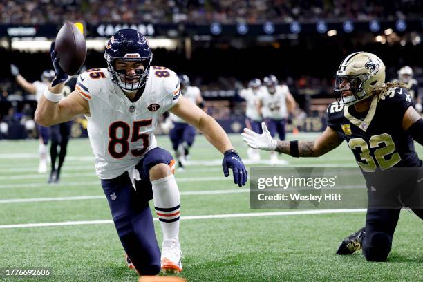 Cole Kmet of the Chicago Bears catches a touchdown pass while defended by Tyrann Mathieu of the New Orleans Saints during the first quarter at...