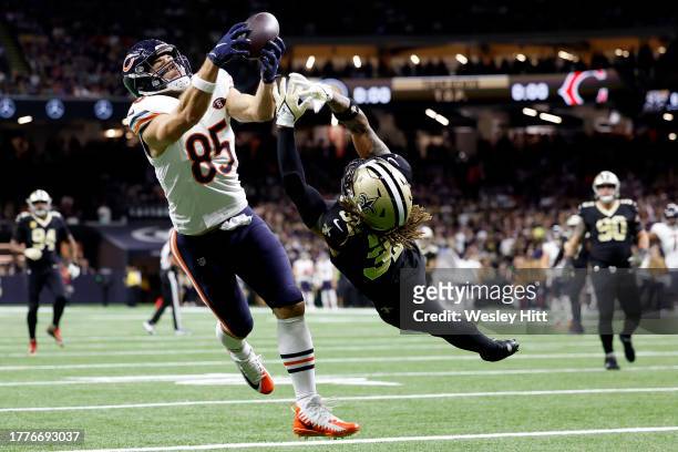 Cole Kmet of the Chicago Bears catches a touchdown pass while defended by Tyrann Mathieu of the New Orleans Saints during the first quarter at...