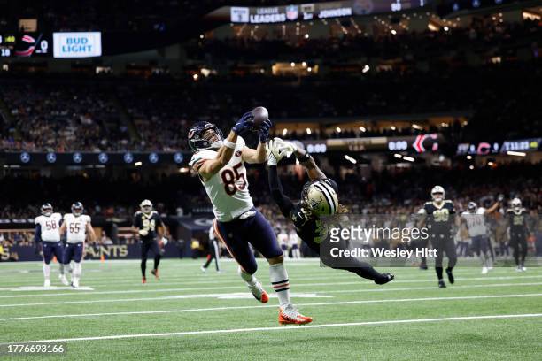 Cole Kmet of the Chicago Bears catches a touchdown pass while defended by Tyrann Mathieu of the New Orleans Saints during the first quarter at...