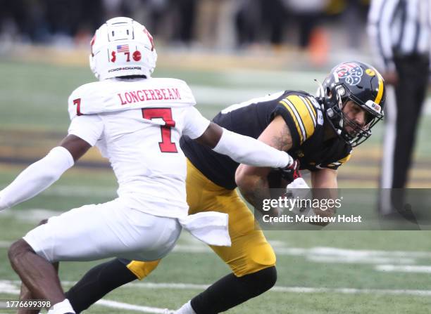 Wide receiver Nico Ragaini of the Iowa Hawkeyes goes up the field during the first half against defensive back Robert Longerbeam of the Rutgers...