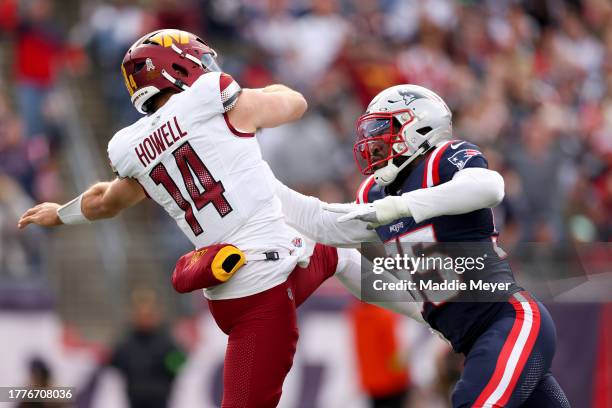 Sam Howell of the Washington Commanders is hit by Josh Uche of the New England Patriots during the first half at Gillette Stadium on November 05,...