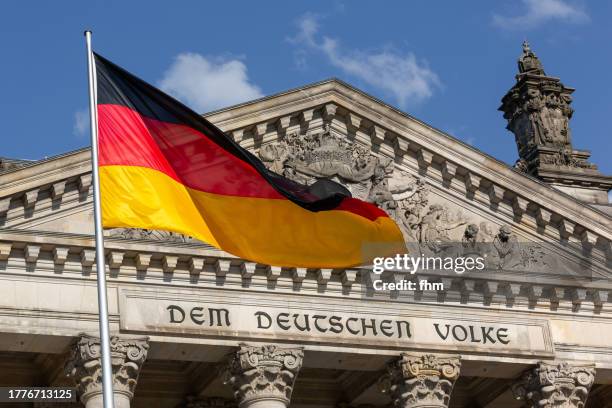 deutscher bundestag - reichstag building with german flag (german parliament building) - berlin, germany - germany stock pictures, royalty-free photos & images
