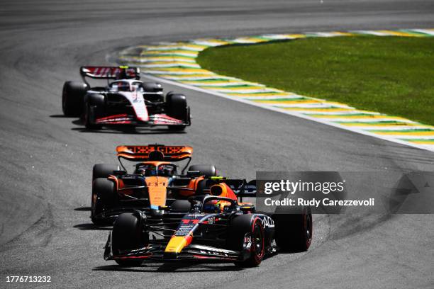 Sergio Perez of Mexico driving the Oracle Red Bull Racing RB19 leads Oscar Piastri of Australia driving the McLaren MCL60 Mercedes on track during...