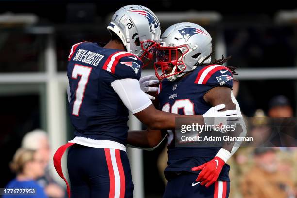 Rhamondre Stevenson of the New England Patriots celebrates a touchdown with JuJu Smith-Schuster during the second quarter in the game against the...