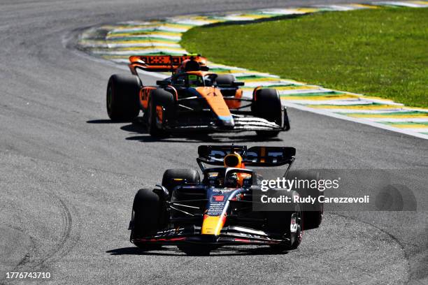 Max Verstappen of the Netherlands driving the Oracle Red Bull Racing RB19 leads Lando Norris of Great Britain driving the McLaren MCL60 Mercedes...