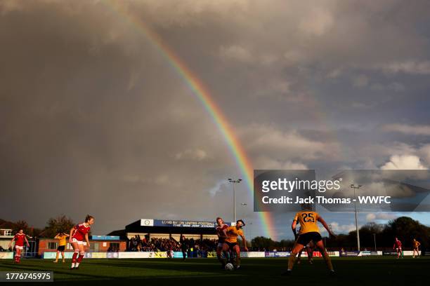 General view as Beth Merrick of Wolverhampton Wanderers is challenged with a rainbow in the background during the FAWNL Northern Premier Division...