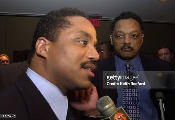 Reverend Jesse Jackson listens to Marlon Jackson at a news conference announcing the Major Broadcasting Cable Network's 24 hour news channel February...