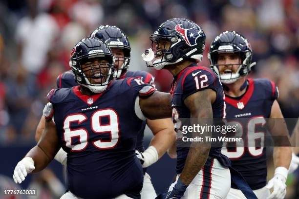 Nico Collins of the Houston Texans celebrates with teammates after a touchdown in the first quarter of a game against the Tampa Bay Buccaneers at NRG...