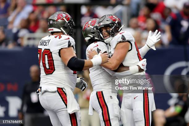 Cade Otton of the Tampa Bay Buccaneers celebrates with teammates after a touchdown in the first quarter of a game against the Houston Texans at NRG...