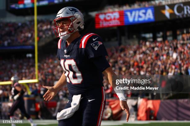 Mac Jones of the New England Patriots celebrates after a touchdown during the first half in the game against the Washington Commanders at Gillette...