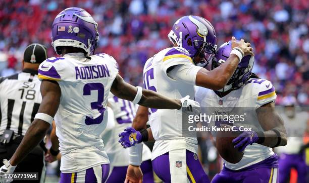 Alexander Mattison of the Minnesota Vikings celebrates his second quarter touchdown against the Atlanta Falcons with Joshua Dobbs of the Minnesota...