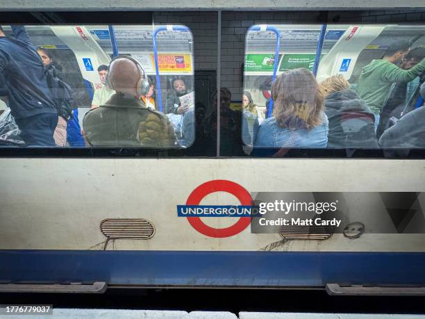 People sit on a London Underground tube train as it waits at a underground station on October 24, 2023 in London, England. With an array of notable...