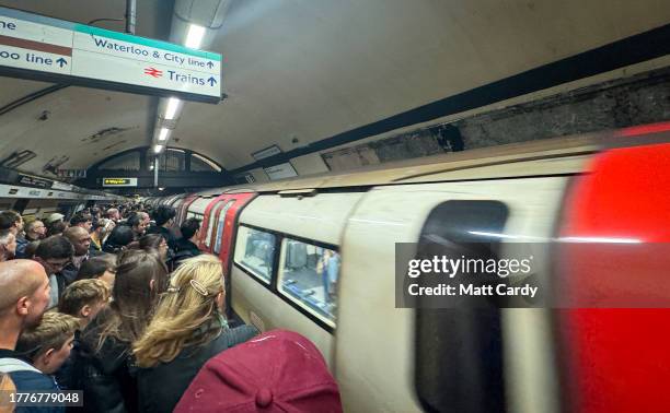 People wait for a London Underground tube train to arrive at a underground station on October 24, 2023 in London, England. With an array of notable...