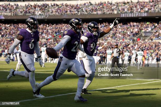 Geno Stone of the Baltimore Ravens celebrates with teammates after an interception against the Seattle Seahawks during the second quarter at M&T Bank...