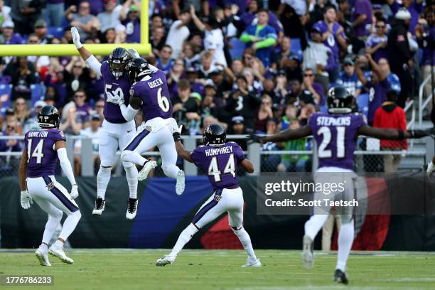 Kyle Van Noy and Patrick Queen of the Baltimore Ravens celebrate a turnover against the Seattle Seahawks during the second quarter at M&T Bank...
