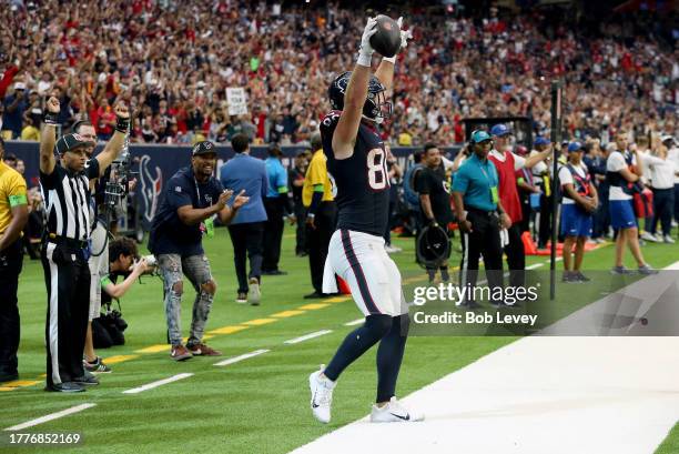 Dalton Schultz of the Houston Texans reacts after a touchdown in the fourth quarter of a game against the Tampa Bay Buccaneers at NRG Stadium on...