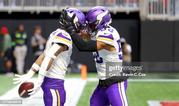 Byron Murphy Jr. #7 of the Minnesota Vikings celebrates an interception during the third quarter of the game with Jordan Hicks of the Minnesota...