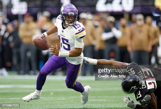Joshua Dobbs of the Minnesota Vikings carries the ball during the third quarter of the game against the Atlanta Falcons at Mercedes-Benz Stadium on...