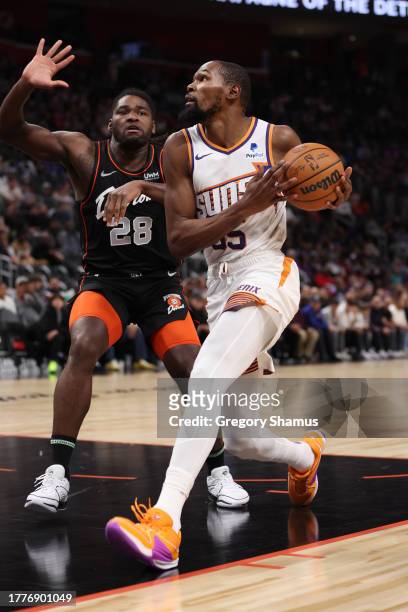 Kevin Durant of the Phoenix Suns drives around Isaiah Stewart of the Detroit Pistons during the first half at Little Caesars Arena on November 05,...