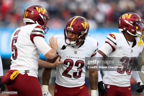 Chris Rodriguez Jr. #23 of the Washington Commanders reacts during the second half in the game against the New England Patriots at Gillette Stadium...