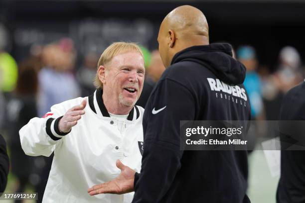 Owner and managing general partner Mark Davis of the Las Vegas Raiders greets interim head coach Antonio Pierce before a game against the New York...