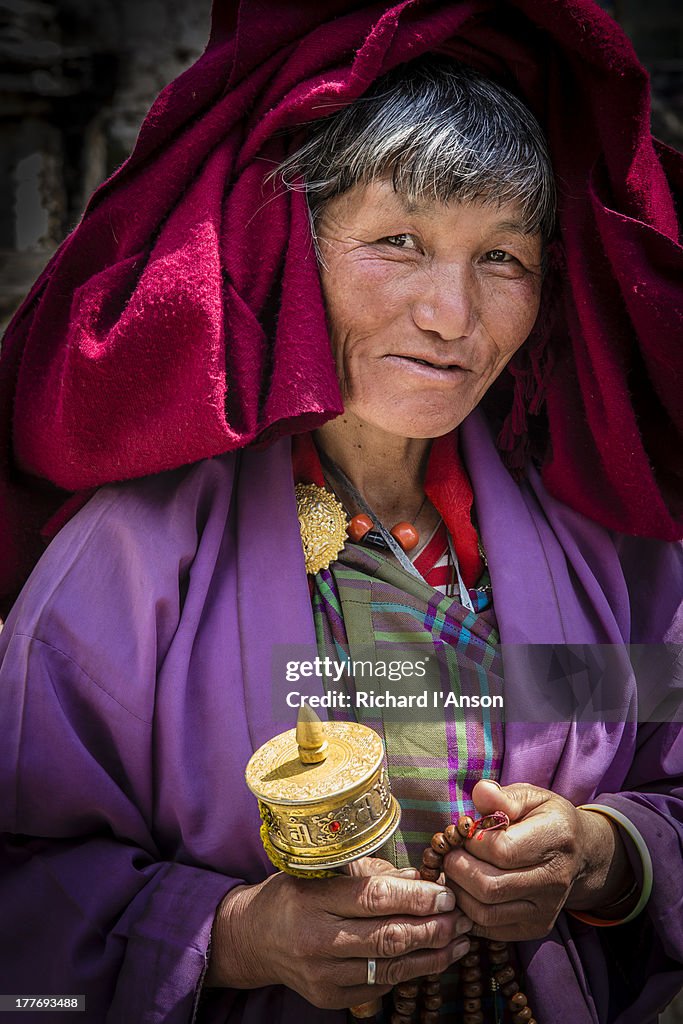 Woman with prayer wheel at Jampey Lhakhang
