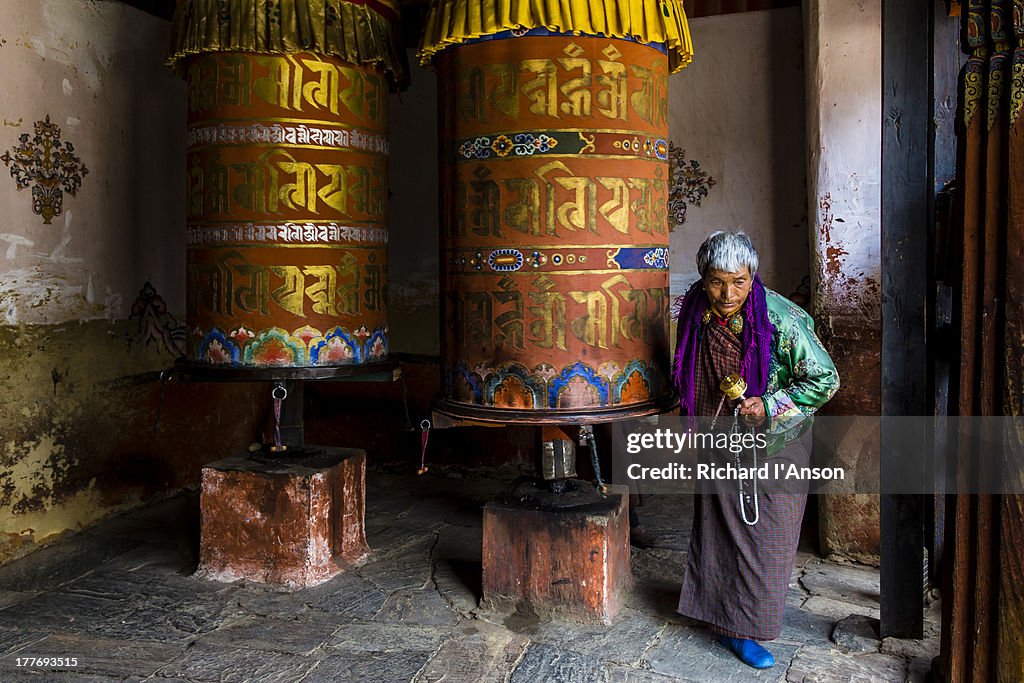 Woman spinning prayer wheel at Jampey Lhakhang