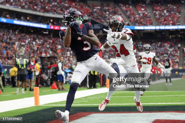 Tank Dell of the Houston Texans catches a touchdown pass against Carlton Davis III of the Tampa Bay Buccaneers in the third quarter of a game at NRG...