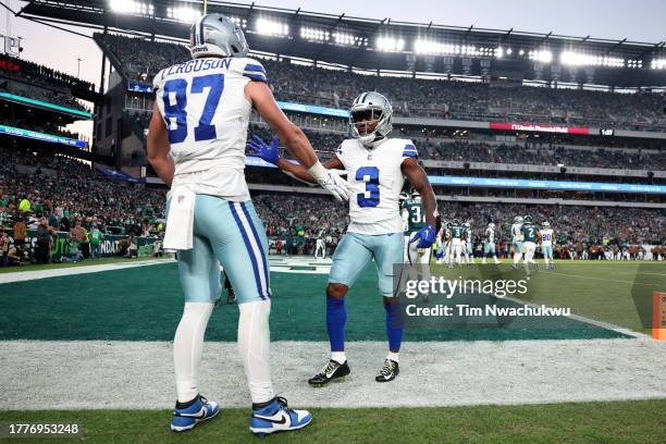 Jake Ferguson of the Dallas Cowboys celebrates after a touchdown with Brandin Cooks of the Dallas Cowboys during the first half in the game against...