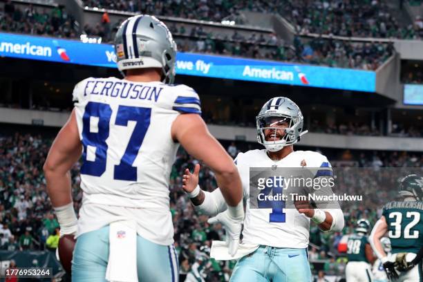 Jake Ferguson of the Dallas Cowboys celebrates after a touchdown with Dak Prescott during the first half in the game against the Philadelphia Eagles...