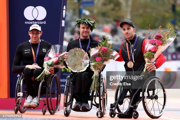 Silver medalist Daniel Romanchuk of the United States, gold medalist Marcel Hug of Switzerland and bronze medalist Jetze Plat of the Netherlands pose...