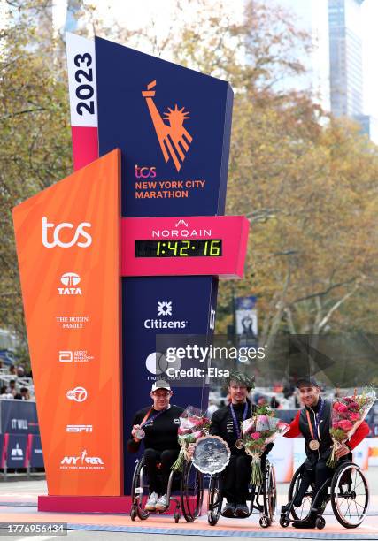 Silver medalist Daniel Romanchuk of the United States, gold medalist Marcel Hug of Switzerland and bronze medalist Jetze Plat of the Netherlands pose...