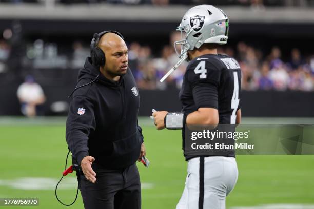 Interim head coach Antonio Pierce of the Las Vegas Raiders high-fives Aidan O'Connell in the first quarter of a game against the New York Giants at...