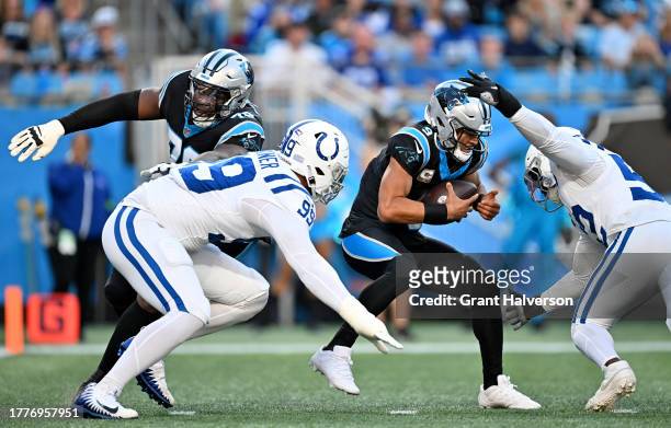 Bryce Young of the Carolina Panthers avoids a sack by DeForest Buckner of the Indianapolis Colts during the first quarter of the game at Bank of...