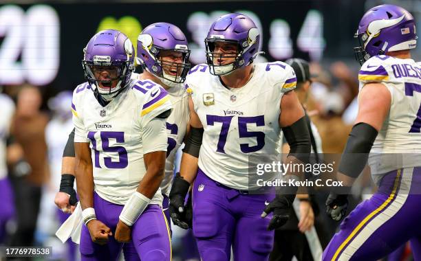 Joshua Dobbs and Brian O'Neill of the Minnesota Vikings celebrate after Brandon Powell of the Minnesota Vikings scores the game winning touchdown...