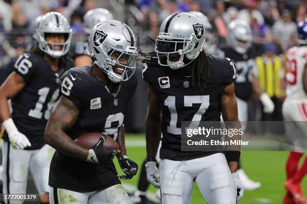 Josh Jacobs of the Las Vegas Raiders celebrates with Davante Adams after scoring a touchdown in the second quarter of a game against the New York...