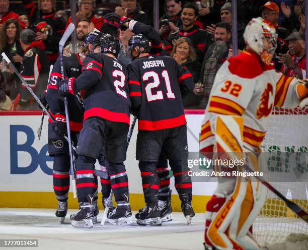 Mathieu Joseph of the Ottawa Senators celebrates his first period goal against the Calgary Flames with teammates Claude Giroux, Artem Zub and Jake...